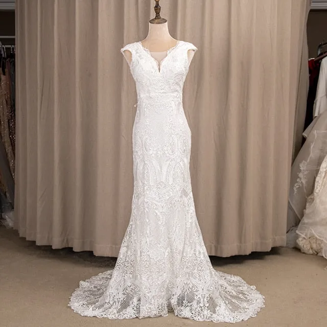 Wedding Dress Features Deep V-Neck Sexy Backless With Cap Sleeves Made In Lace Sheath Boho Style